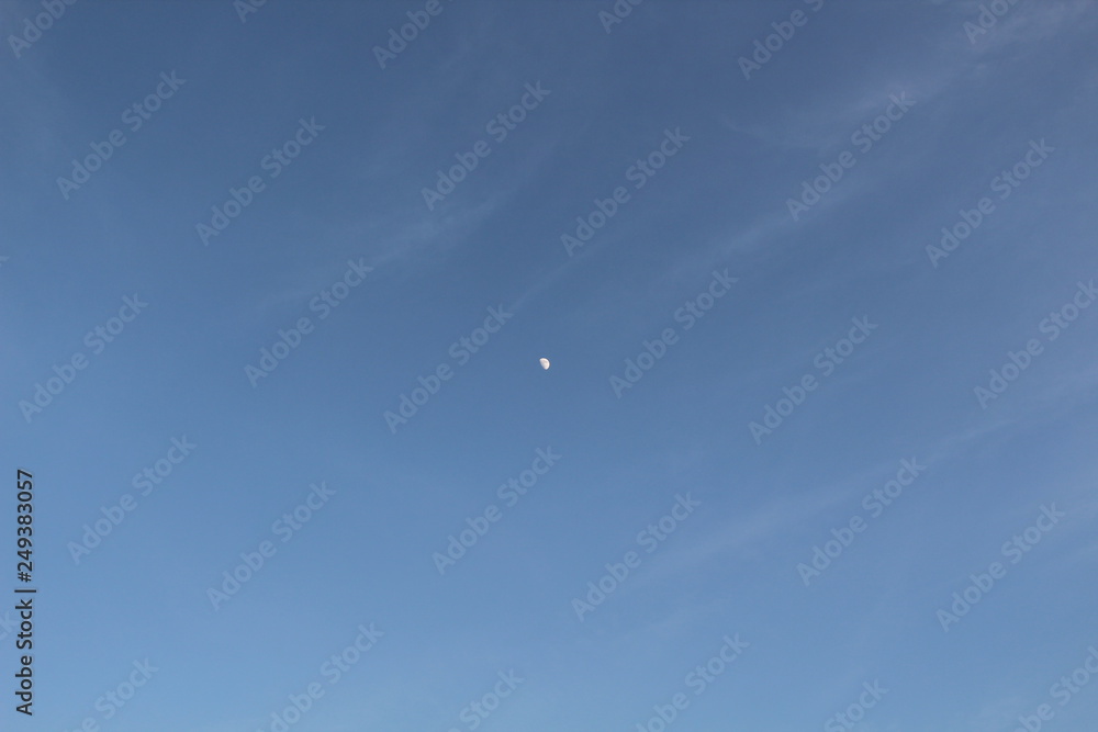 The moon in the blue sky