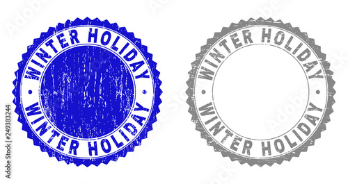 Grunge WINTER HOLIDAY stamp seals isolated on a white background. Rosette seals with grunge texture in blue and grey colors. Vector rubber stamp imitation of WINTER HOLIDAY title inside round rosette.
