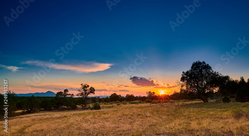 Tableau sur toile Sunset Over Open Field
