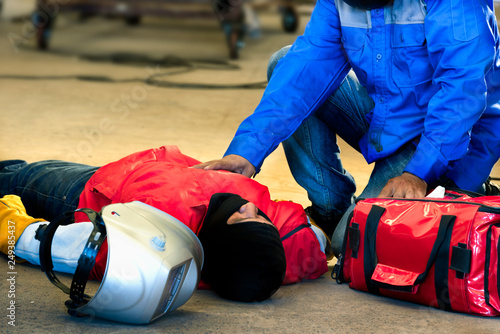 First aid training in the factory industrial. Welder accident in works and fainting in a factory industrial. Safety and protection equipment in works of the construction industry.