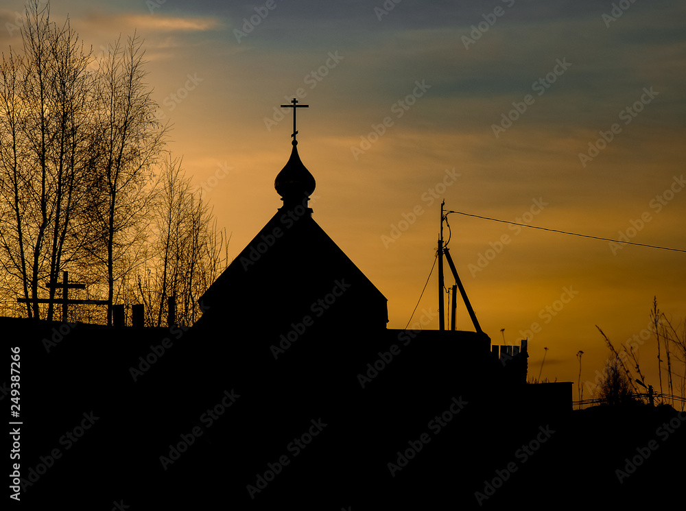 silhouette of a church on the sunset