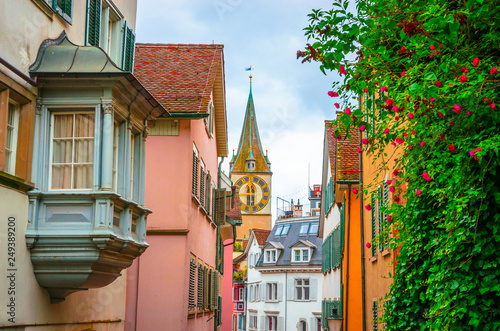 Beautiful cozy street and tower of Saint Peter church in the city center of Zurich, Switzerland