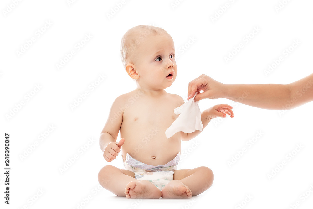 Portrait of a baby getting a diaper change: mom wiping baby's bottom with baby wipe isolated on a white background. concept cleaning wipe, pure, clean Portrait of a baby getting a diaper change: mom wiping baby's bottom with baby wipe isolated on a white background. concept cleaning wipe, pure, clean
