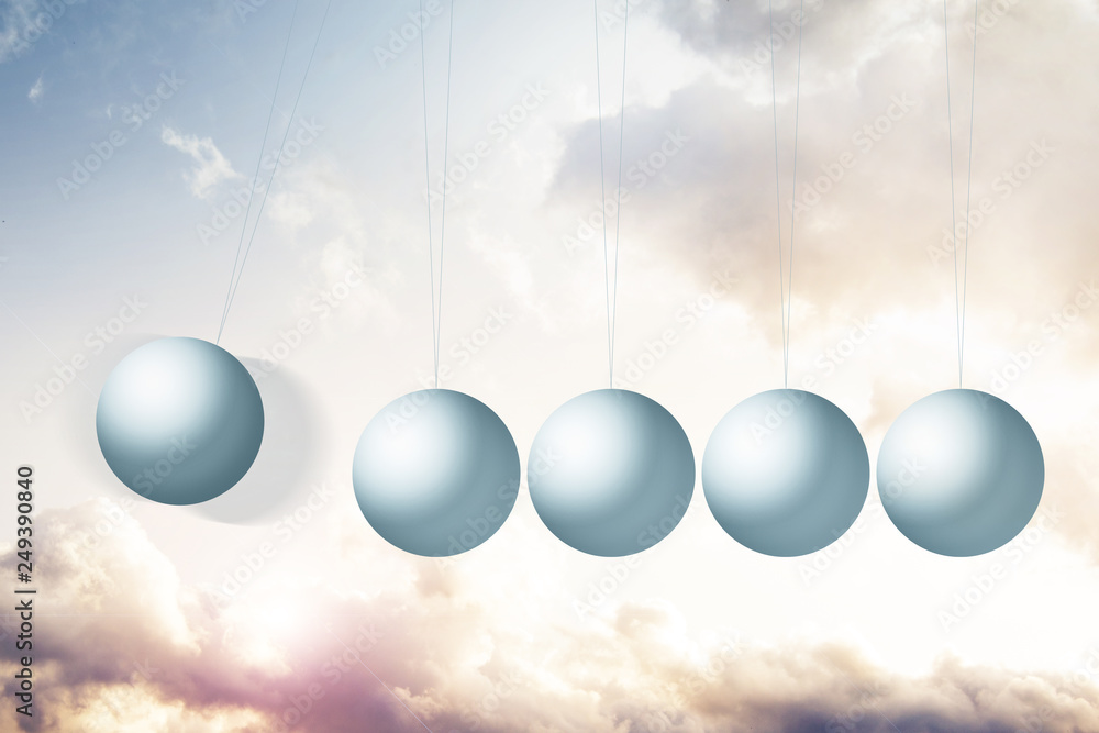 Newton's cradle on fantasy background with colorful clouds Newton's cradle on fantasy background with colorful clouds