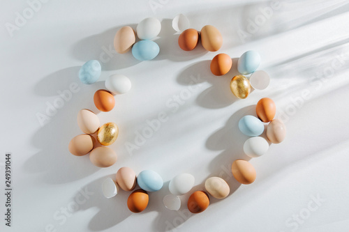 Frame made of Natural Colored Eggs with morning sunlights. Stylish Compositions in pastel colors. Easter concept.