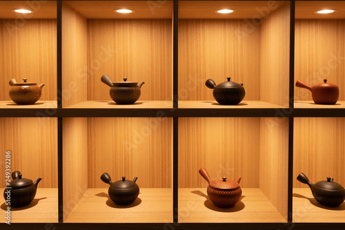 Quadro su tela Traditional Japanese pots used for tea ceremony on grid shelves