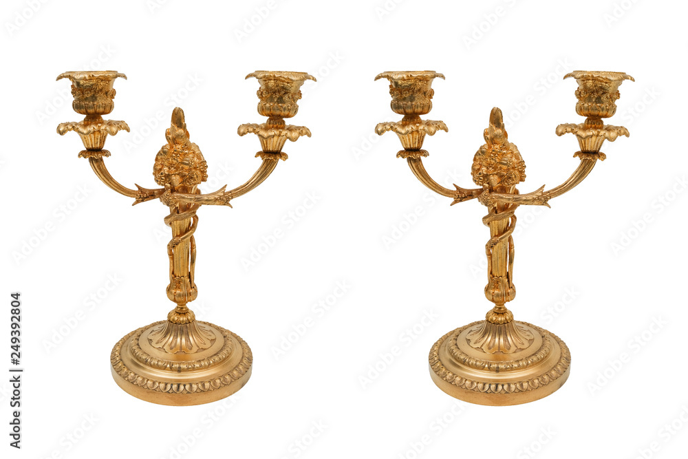 Vintage pair of bronze candlesticks on a white background.