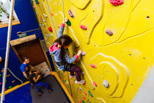 Little Girl Climbing Rock Wall