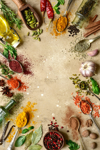 Fototapeta Naklejka Na Ścianę i Meble -  Assortment of natural spices on a spoons. Top view with copy space.