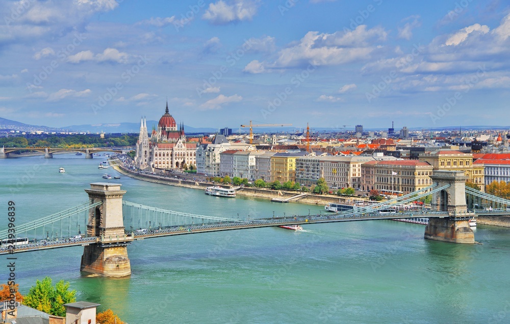 Fototapeta premium Incredible spectacular picturesque view of Hungarian Parliament and chain bridge in Budapest, Hungary. Panorama cityscape of famous tourist destination Budapest with Danube, parliament and bridges.