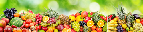 Panoramic skinali from bright fresh vegetables  fruits  berries on green blurred background.