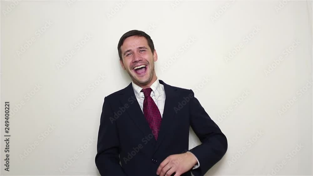 Young handsome businessman actively laughs with good jokes colleagues.Portrait on white background Young handsome businessman actively laughs with good jokes colleagues.Portrait on white background