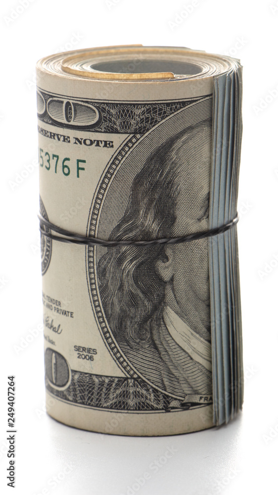 100 dollar bills twisted into tube and tied with an elastic band. white background. 100 dollar bills twisted into tube and tied with an elastic band. white background.