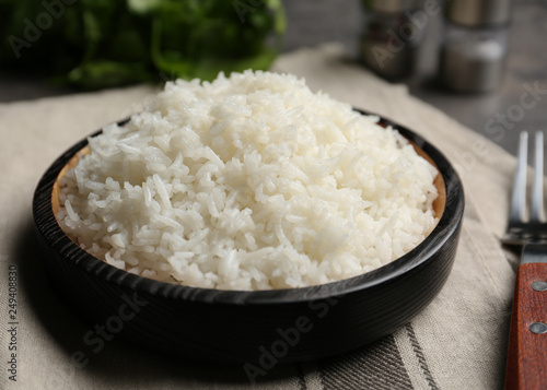 Boiled rice in bowl on napkin, closeup