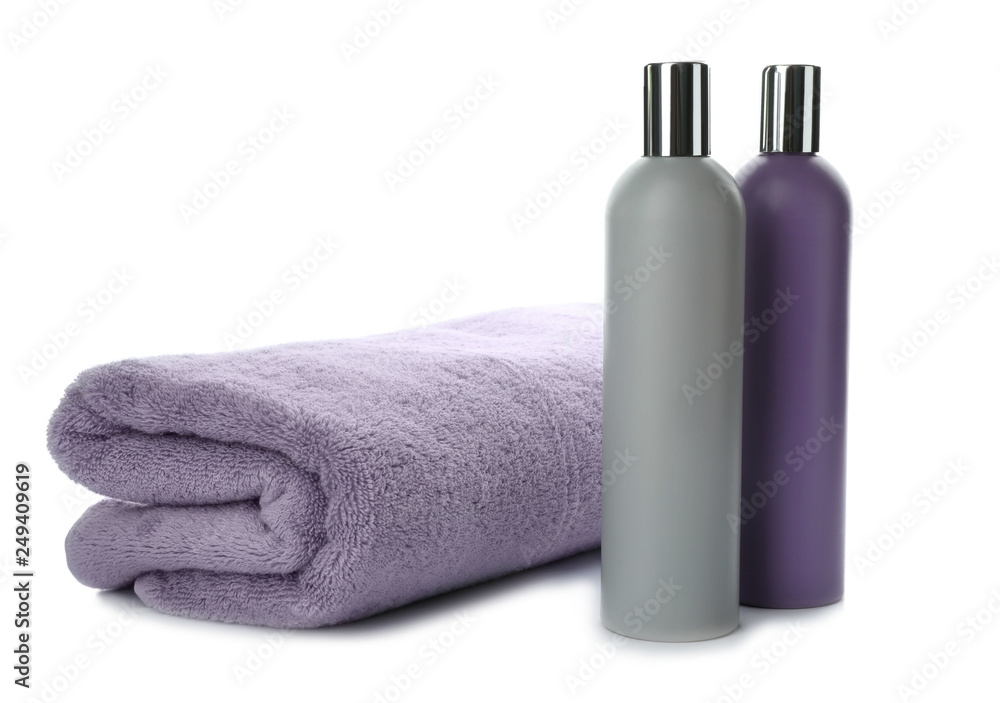 Folded towel and shampoo isolated on white Folded towel and shampoo isolated on white