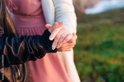 Close-up of a man's hand holding a woman's hand