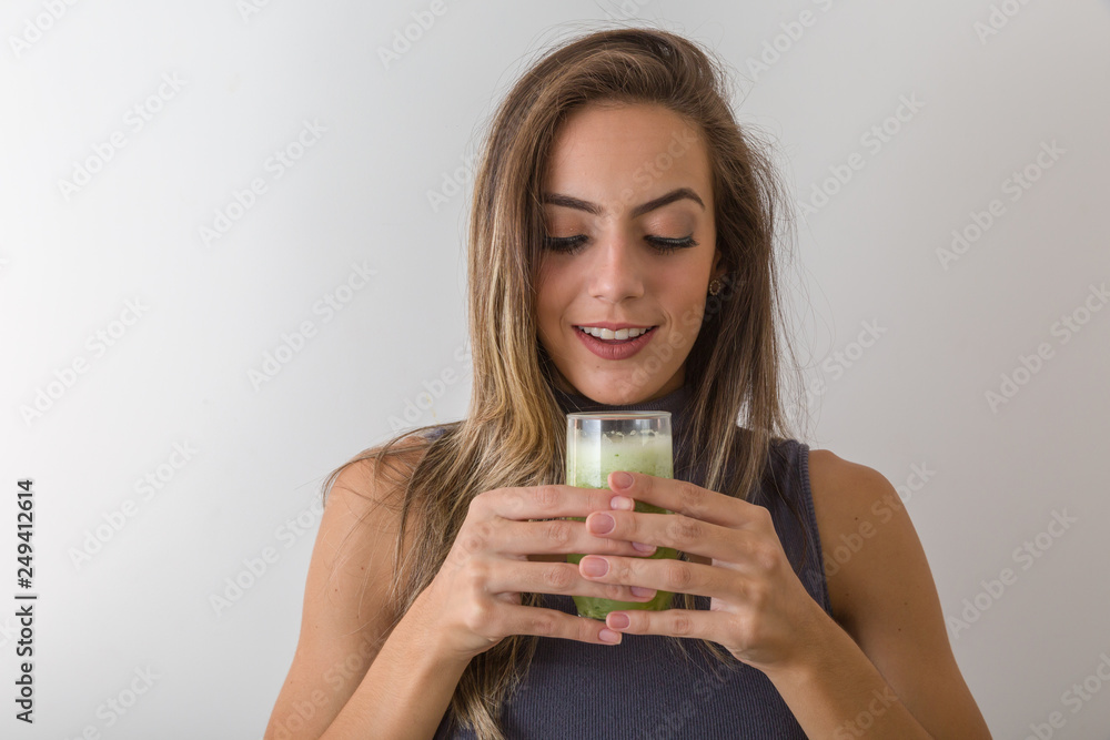Healthy food eating. Happy beautiful smiling woman drinking green detox vegetable smoothie. Diet. Healthy lifestyle, vegetarian meal. Drink juice. Health care and beauty concept. Healthy food eating. Happy beautiful smiling woman drinking green detox vegetable smoothie. Diet. Healthy lifestyle, vegetarian meal. Drink juice. Health care and beauty concept.