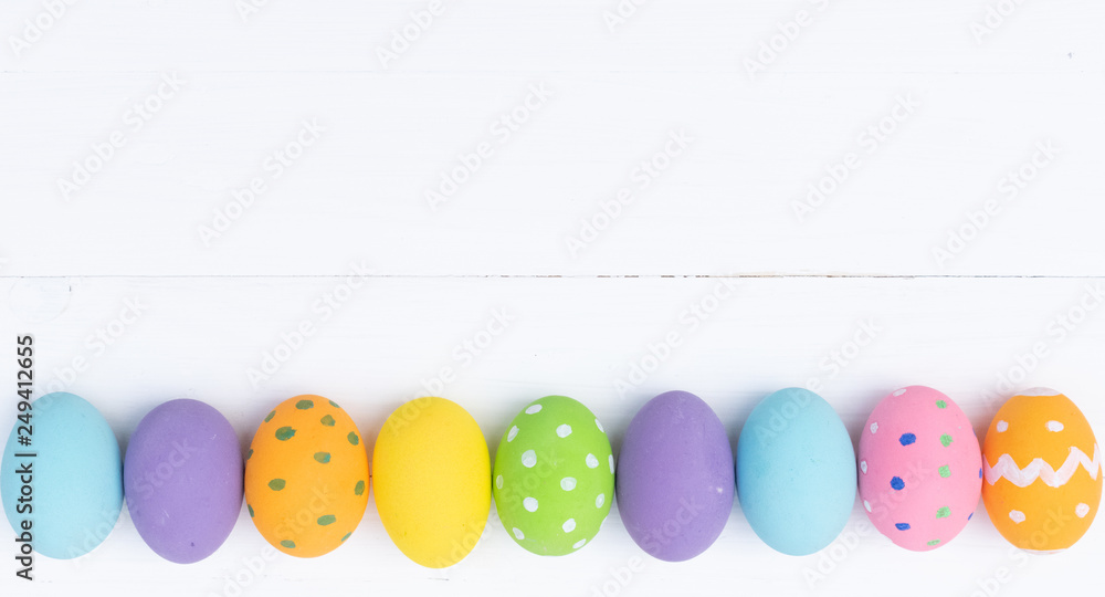 Easter eggs concept. Happy Easter Day. Row Easter eggs on white wooden background. Easter eggs concept. Happy Easter Day. Row Easter eggs on white wooden background.