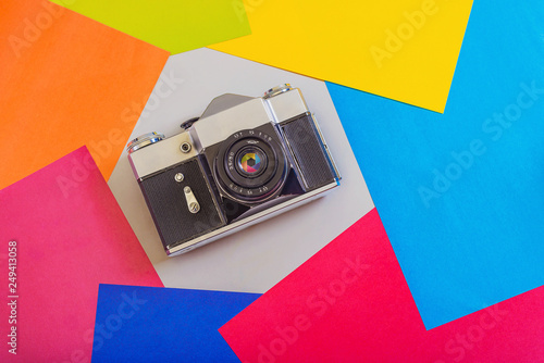 Retro photo camera on a colored background. The concept of vivid memories. photo