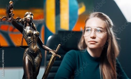 Scales of justice  the concept of jurisprudence. Young woman judge  lawyer  attorney.