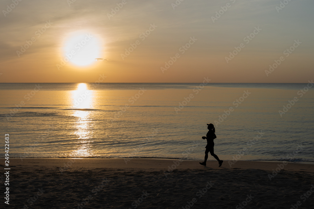 silhouette picture of running on the sand beach during sunrise. healthy and running sport concept