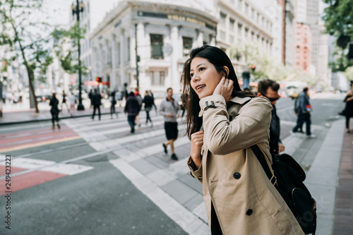 Photography female asian tourist with curious face smiling standing on sidewalk