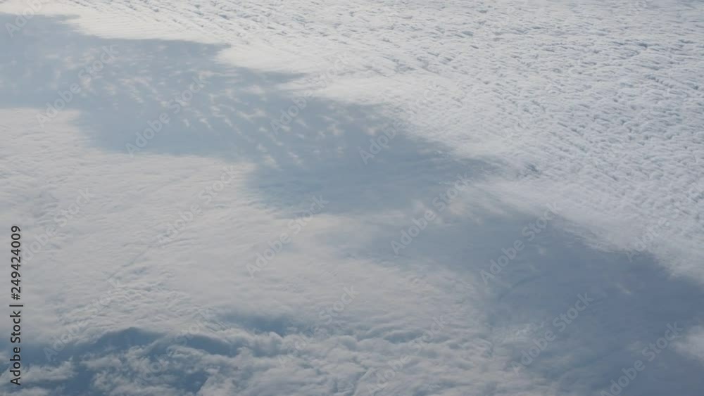 Traveling by air. Bird's eye view through an airplane window. Beautiful cloudscape. Traveling by air. Bird's eye view through an airplane window. Beautiful cloudscape.