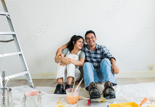 Couple resting after painting the room photo