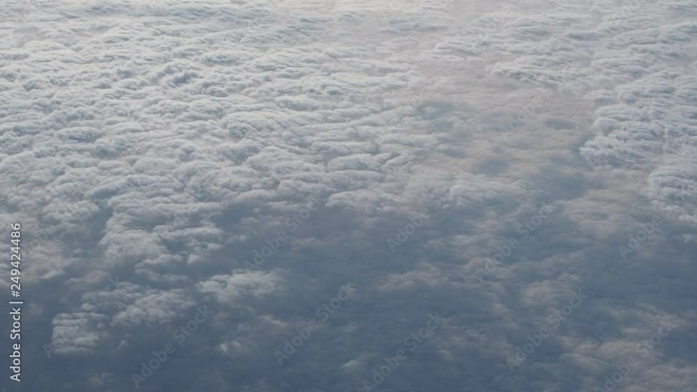 Traveling by air. Bird's eye view through an airplane window. Beautiful cloudscape. Traveling by air. Bird's eye view through an airplane window. Beautiful cloudscape.