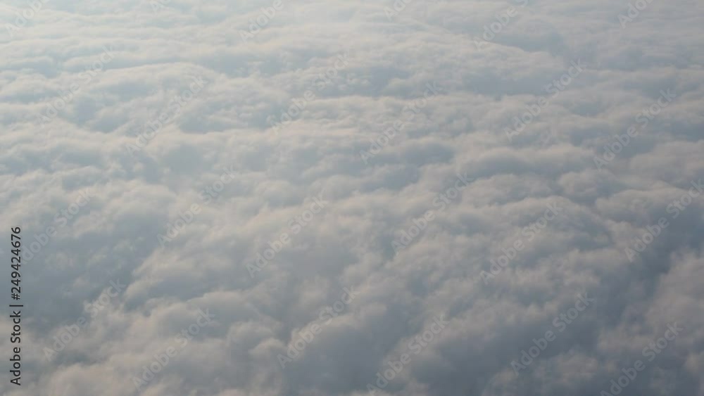 Traveling by air. Bird's eye view through an airplane window. Beautiful cloudscape. Traveling by air. Bird's eye view through an airplane window. Beautiful cloudscape.