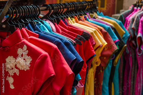 Colorful chinese cheongsam hanging for sale during Chinese New Year.