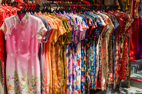Colorful chinese cheongsam hanging for sale during Chinese New Year. photo