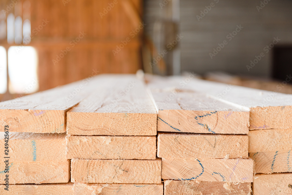 Timber at work. Lumber stockpiled. The boards are stacked. Boards for sale in stock. Timber at work. Lumber stockpiled. The boards are stacked. Boards for sale in stock.