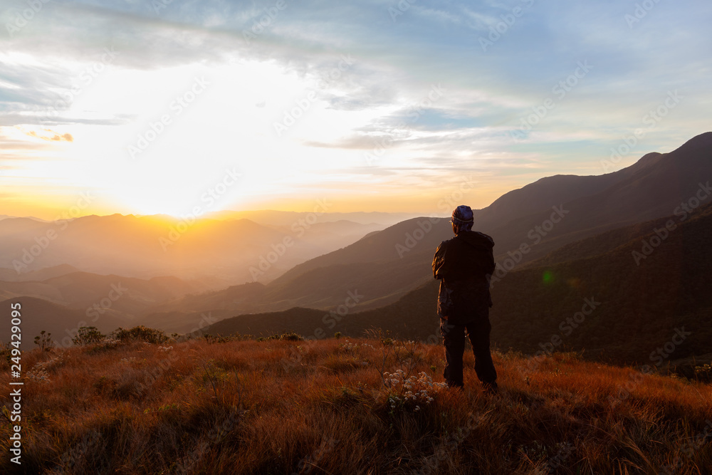 Unrecognized people enjoying the mountain landscape view from a mountain