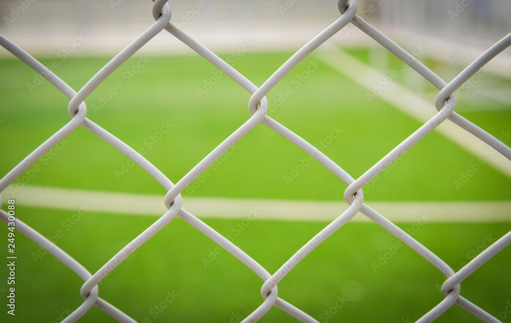Steel cage foreground with green grass sport outdoor Football field - Futsal field Steel cage foreground with green grass sport outdoor Football field - Futsal field
