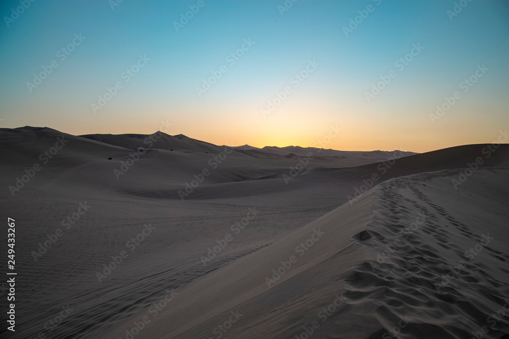 Desert during sunset at Huacachina Oasis in Ica, Peru.