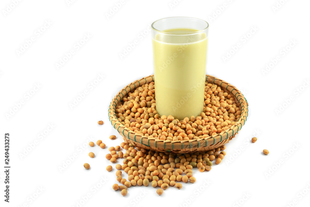 Soy milk in the glass and soybean seeds on threshing basket isolated on white background - soya beans Soy milk in the glass and soybean seeds on threshing basket isolated on white background - soya beans