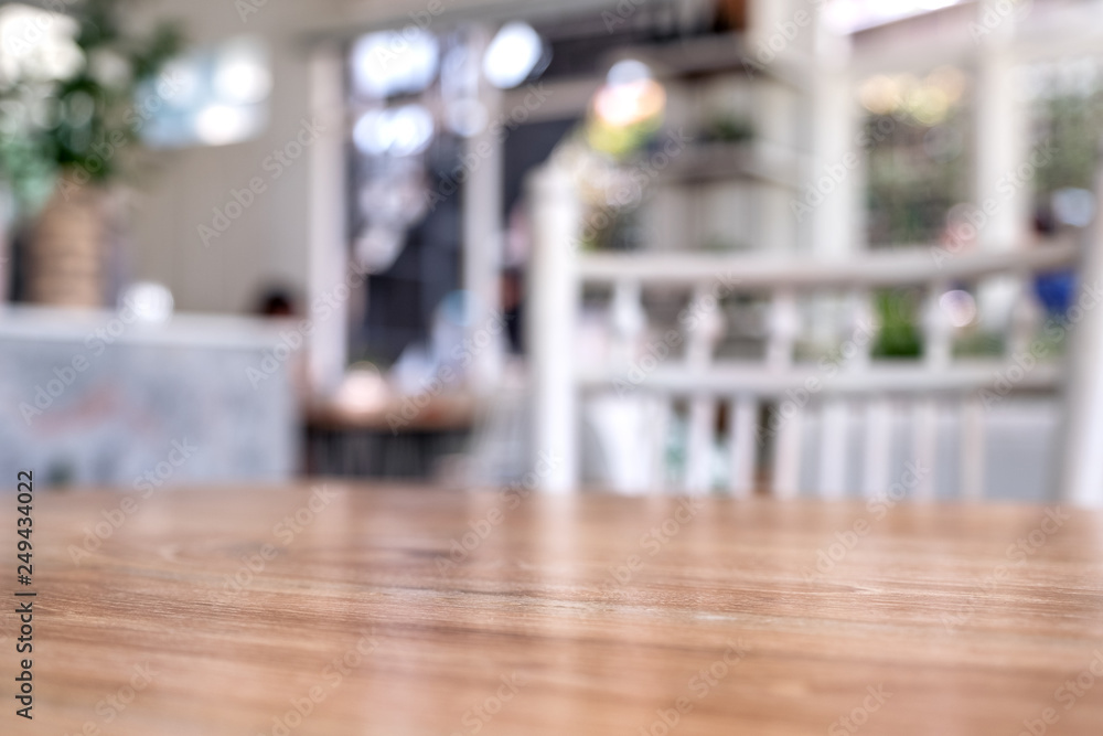Wooden table and white chairs with blurred background in cafe Wooden table and white chairs with blurred background in cafe