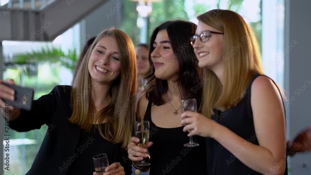 Typical party scene - beautiful girls drink champagne and have fun Typical party scene - beautiful girls drink champagne and have fun