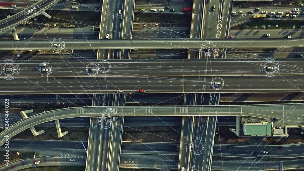 Aerial view from above of traffic on the elevated expressway with futuristic autonomous, driverless cars using artificial intelligence computer network and satellite gps for navigation Aerial view from above of traffic on the elevated expressway with futuristic autonomous, driverless cars using artificial intelligence computer network and satellite gps for navigation