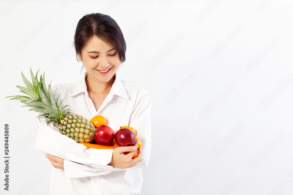 Asian Young Woman holding fresh fruit and vegetable. Healthy diet concept. Asian Young Woman holding fresh fruit and vegetable. Healthy diet concept.