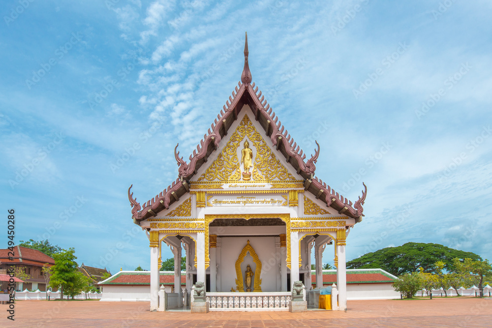 church, pagoda, the sanctuary of the temple at Wat Phra Borommathat Chaiya as background blue sky, Surat Thani, Thailand.