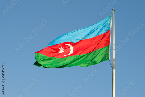 Flag of Azerbaijan flies against the blue sky