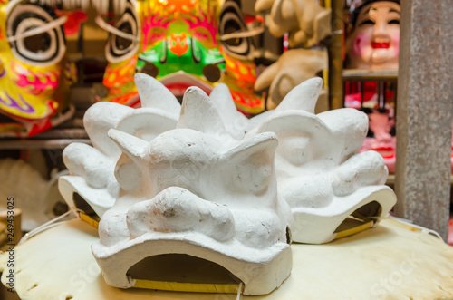 Traditional chinese lion dance head mold display on the shelves.  photo