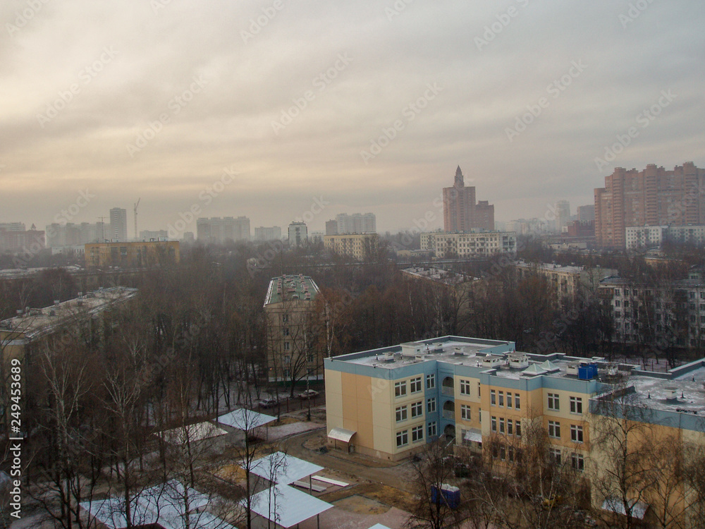 View from the height of the city landscape with houses of different heights going beyond the horizon