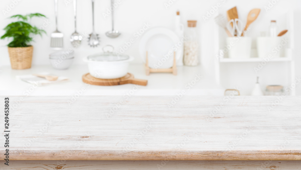 Rustic wooden table top on blurred kitchen shelf background Rustic wooden table top on blurred kitchen shelf background