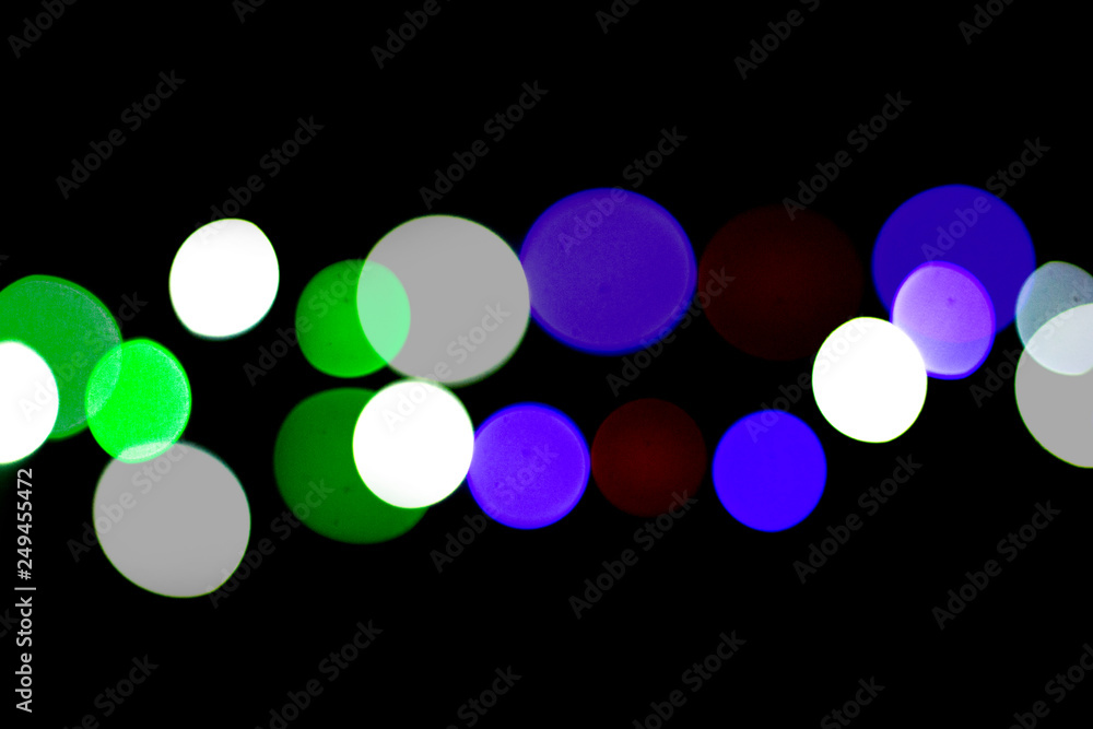 Multicolored bokeh on black background. Can be used as a background or wallpaper Multicolored bokeh on black background. Can be used as a background or wallpaper