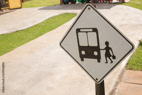 road sign with kids and bus