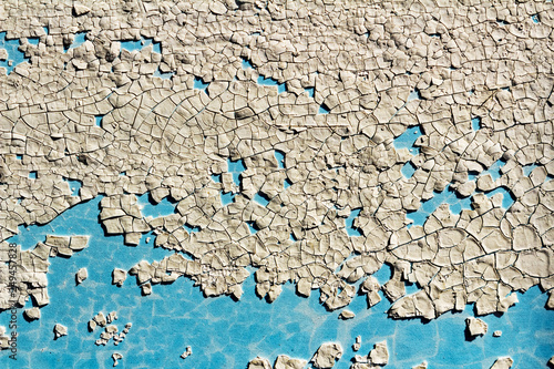 texture of cracked white paint on the wall with a blue background