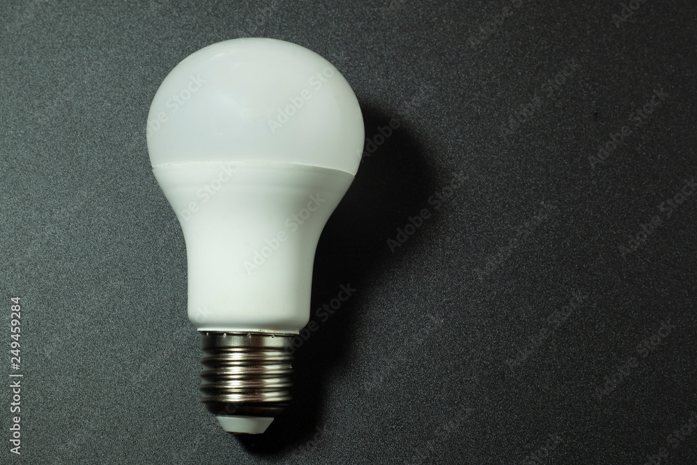 LED lamp on a dark background, designed to illuminate the home, street and other rooms LED lamp on a dark background, designed to illuminate the home, street and other rooms